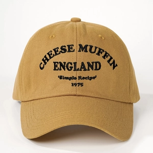 Detailed view of khaki cotton baseball cap featuring vintage Cheese Muffin embroidery