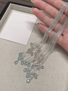 Detail of adjustable S925 silver necklaces with blue teardrop sapphire pendants