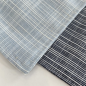Macro detail of blue cotton linen placemat showing textured weave and fabric quality