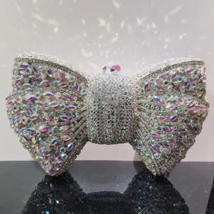 Macro shot of colorful rhinestone bow clutch bag with shimmering rainbow crystal details