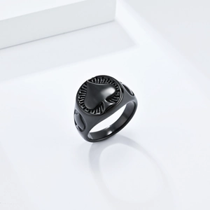 Macro detail of men's matte black titanium Ace of Spades ring with radial textures