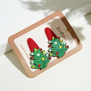 Detail of Christmas tree hair clips with colorful ornaments on red felt base
