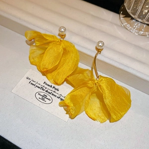 Close-up of lace organza petal earrings with pearls and gold-tone metal hooks