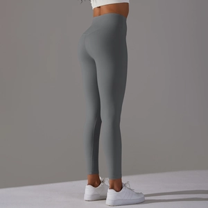 Detail of high-waisted peach lift yoga pants in matte gray fabric with seamless design