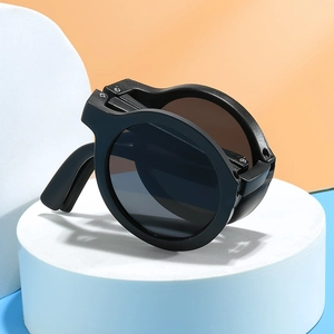 Foldable round kids sunglasses in black finish shown in folded state for easy storage