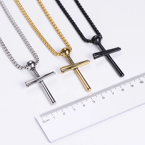Detailed view of silver, gold, and black baseball cross pendants with measuring ruler
