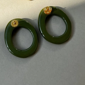 Deep green resin oval earrings with gold metal clasp in a minimalist geometric style