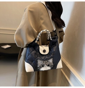 Quilted tote with grey plush cat detail and checkerboard handle shown on model
