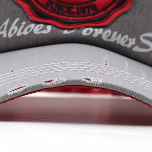 Detail of distressed baseball cap brim with vintage 1978 embroidery and red accents