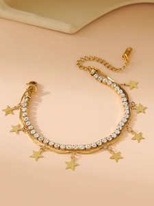 Detailed close-up of double-layer gold plated tennis chain with star charms and zircons