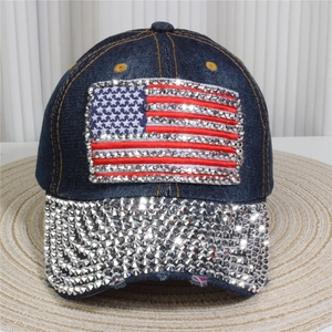 Detailed view of denim baseball cap featuring rhinestone American flag and silver studs