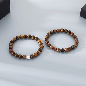 Close-up of dual tiger eye stone bead elastic bracelets with unique marble and matte accents