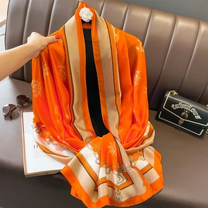 Nautical print silk scarf in orange and beige with anchor patterns for beach sun protection