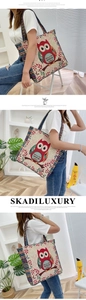 Detail of canvas tote bag with cartoon owl pattern and colorful ethnic woven straps
