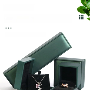 Detailed view of green brushed leather jewelry boxes with soft black velvet interior lining