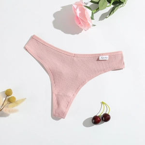 Pink ribbed cotton T-back thong with breathable texture on white background with floral decor