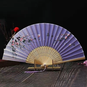 Detail of purple folding fan with flower butterfly motifs and bamboo carved ribs