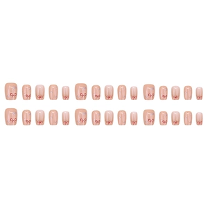 Unghie finte corte squadrate rosa nudo con fiocchi rossi e glitter argentati