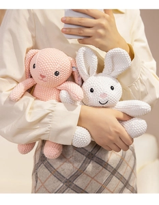 Detailed macro view of handmade crochet bunny plush dolls with soft knitted textures
