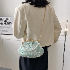 Elegant mint green shell bag with pearls, satin finish, and dual chains for women