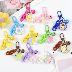 Flat lay of colorful cartoon charms including butterflies and bees on white table