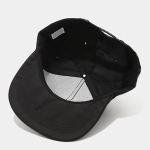 Internal view of black hip-hop baseball cap showing 100% cotton material and snapback