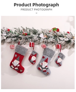 Detail of Christmas gnome stockings with plush trim and wooden buttons hanging decorations