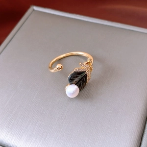 Detailed macro view of the vintage gold butterfly ring with black leaves and pearls