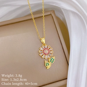 Detailed close-up of golden sunflower pendant with pink and green zircon crystals