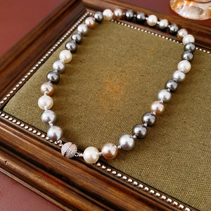 Detail of multi-color pearl necklace with a sphere pavé zircon magnetic clasp