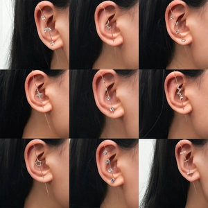 Detailed grid of gold crawler earrings with sparkling zircon stars and geometric shapes