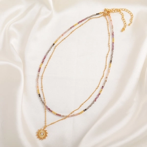 Double-layered necklace with sun pendant, evil eye motif, and colorful natural stone beads