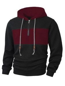 Detail of waffle knit fabric and 1/4 zipper on bicolor burgundy and black hoodie