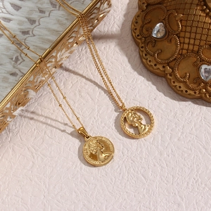 Classic gold coin pendant necklace featuring an embossed portrait of Elizabeth II