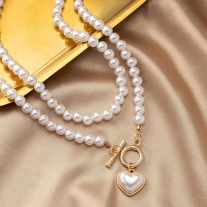 French vintage pearl necklace with golden T-bar clasp and heart pearl pendant on silk