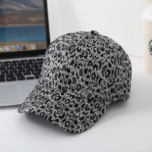 Close-up of black and white leopard jacquard baseball cap with woven floral patterns