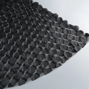 Detail of black strapless dress featuring 3D mesh fabric and polka dot embroidery texture