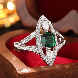 Elegant silver ring with square green gemstone and marquise zircons in a luxury box