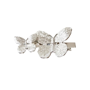 Elegant silver butterfly hair clip with detailed metallic wings and a duckbill grip