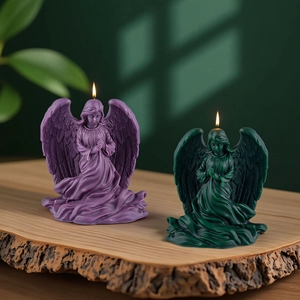 Pair of angel-shaped candles in purple and dark green on a rustic wood stand