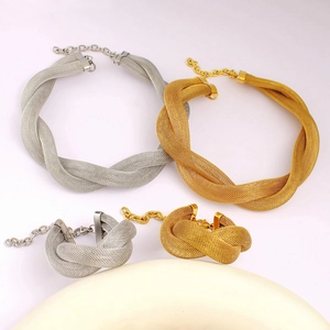 Detail of gold and silver mesh woven twist necklace and bracelet with lobster clasp