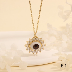 Macro shot of evil eye pendant with brown iris and zircons on gold chain necklace