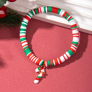 Detail of Christmas candy cane charm bracelet with red green and white clay beads