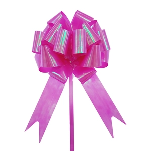 Close-up of pink iridescent ball bow gift ribbon with holographic finish for gift wrapping