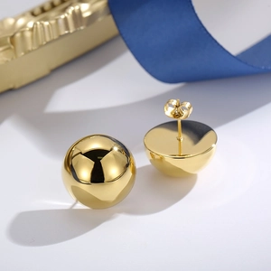 Minimalist golden dome stud earrings with polished mirror finish and butterfly backs