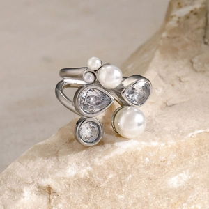Macro detail of 18k gold stainless steel ring with white pearls and zircon clusters