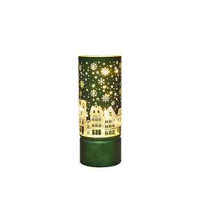 Green Christmas lantern with cutout snowflake and European architecture warm light