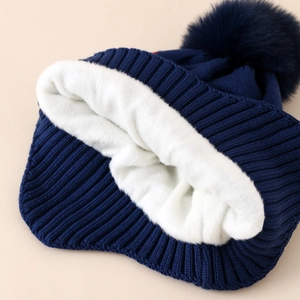 Winter kids knit hat with warm white fleece lining and navy blue pom pom