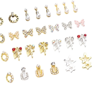 Assorted alloy nail charms featuring butterflies, stars, and rings with pearls and rhinestones