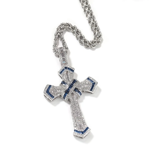 Close-up of hip hop cross pendant with blue and white zircons on silver chain